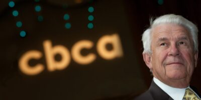 Image of CBCA's Founder John Madden, Jr. with CBCA logo in the background