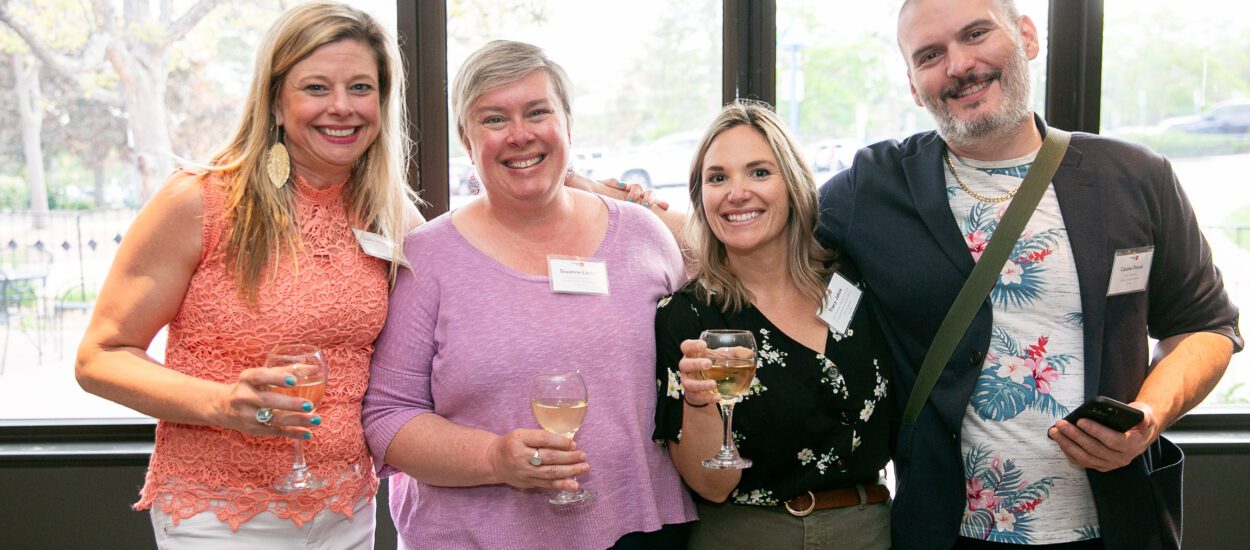 Four CBCA members smile at a networking event.